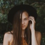 portrait photo of woman fixing her hair